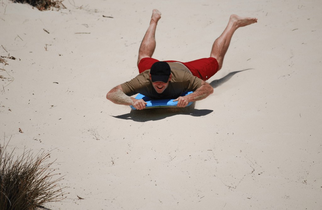 Sandboarding on Ninety Mile Beach, New Zealand North Island