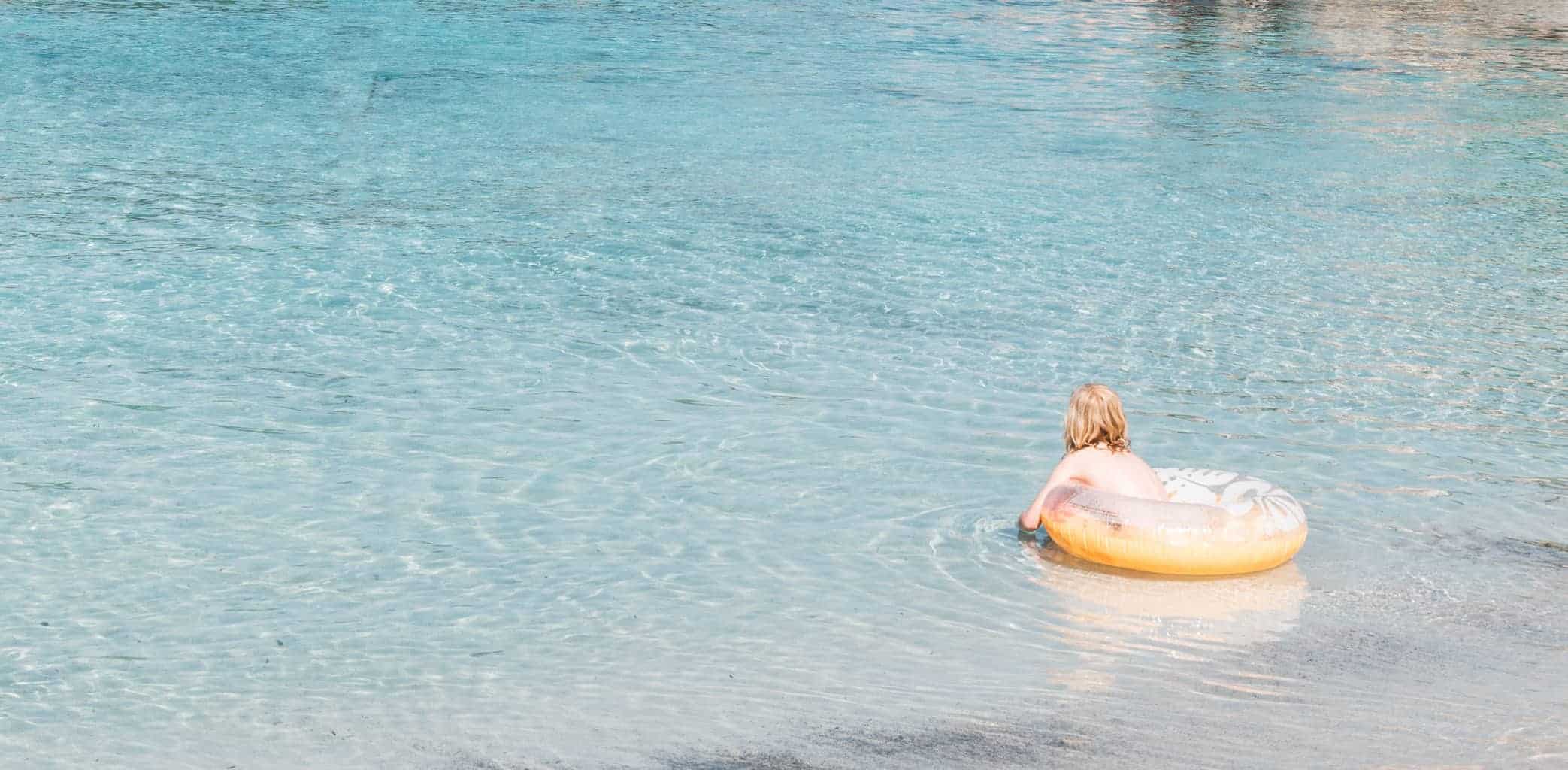 Girl swimming at S'Amarador beach in Mallorca