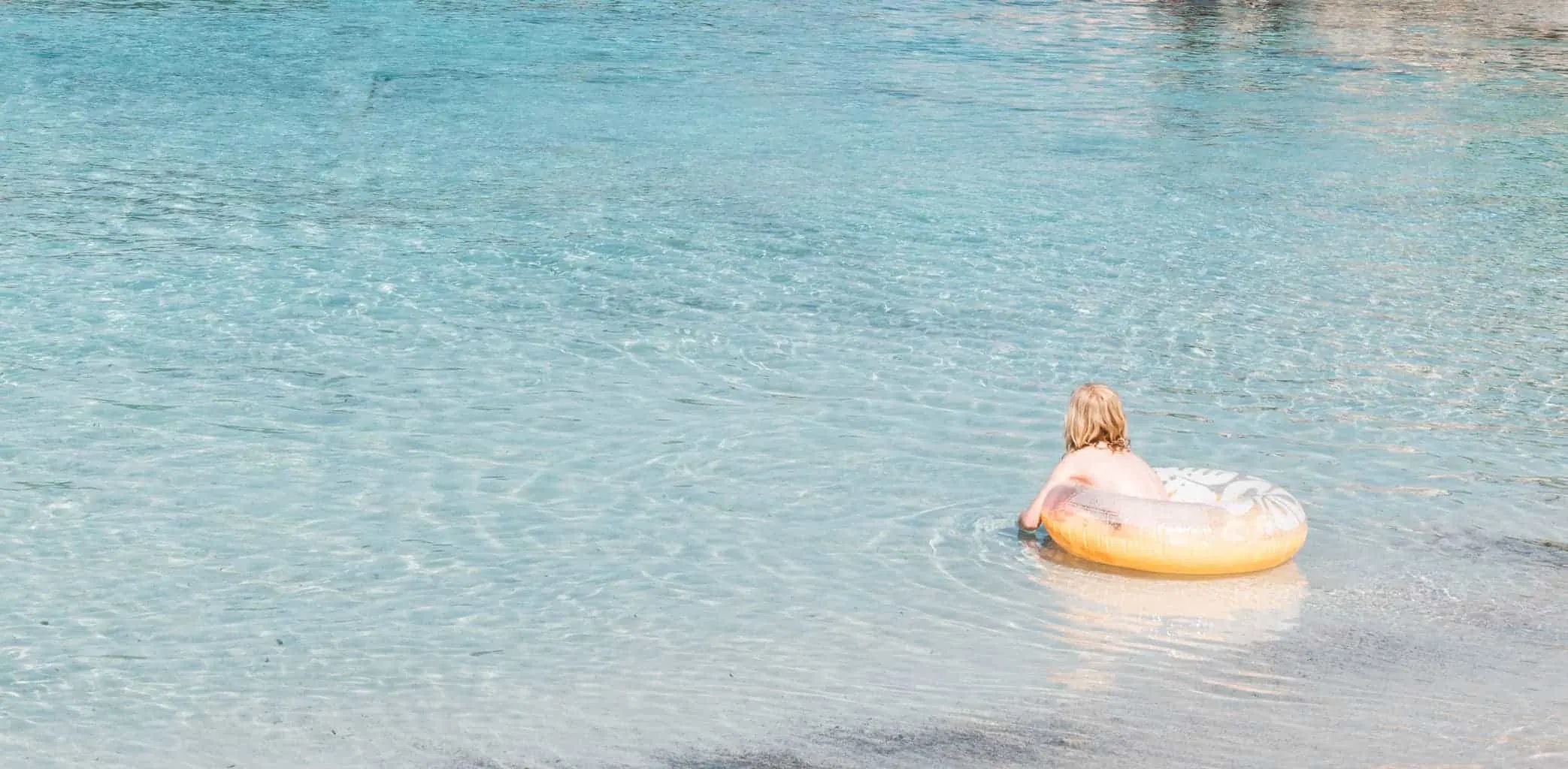 Girl swimming at S'Amarador beach in Mallorca