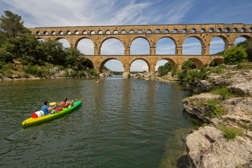 Pont du Gard with a kayak going under it